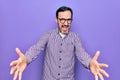 Middle age handsome man wearing casual shirt and glasses over isolated white background looking at the camera smiling with open Royalty Free Stock Photo