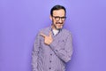 Middle age handsome man wearing casual shirt and glasses over isolated white background smiling cheerful pointing with hand and Royalty Free Stock Photo