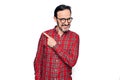 Middle age handsome man wearing casual shirt and glasses over isolated white background smiling cheerful pointing with hand and Royalty Free Stock Photo