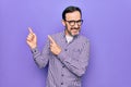 Middle age handsome man wearing casual shirt and glasses over isolated white background smiling and looking at the camera pointing Royalty Free Stock Photo