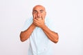 Middle age handsome man wearing casual shirt standing over isolated white background shocked covering mouth with hands for mistake Royalty Free Stock Photo