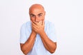 Middle age handsome man wearing casual shirt standing over isolated white background shocked covering mouth with hands for mistake Royalty Free Stock Photo