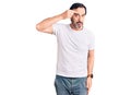 Middle age handsome man wearing casual t-shirt pointing unhappy to pimple on forehead, ugly infection of blackhead Royalty Free Stock Photo