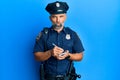 Middle age handsome man wearing police uniform writing traffic fine skeptic and nervous, frowning upset because of problem