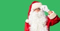 Middle age handsome man wearing Santa Claus costume and beard standing pointing unhappy to pimple on forehead, ugly infection of Royalty Free Stock Photo