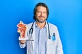 Middle age handsome otologist doctor man holding medical model looking positive and happy standing and smiling with a confident