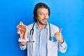 Middle age handsome otologist doctor man holding medical model smiling happy and positive, thumb up doing excellent and approval