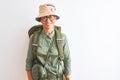 Middle age hiker woman wearing backpack canteen hat glasses over isolated white background with a happy and cool smile on face Royalty Free Stock Photo