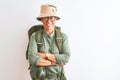 Middle age hiker woman wearing backpack canteen hat glasses over isolated white background happy face smiling with crossed arms Royalty Free Stock Photo