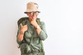 Middle age hiker woman wearing backpack canteen hat glasses over isolated white background looking confident at the camera with Royalty Free Stock Photo