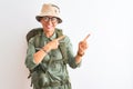 Middle age hiker woman wearing backpack canteen hat glasses over isolated white background smiling and looking at the camera Royalty Free Stock Photo