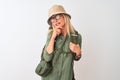 Middle age hiker woman wearing backpack hat canteen glasses over isolated white background looking confident at the camera with Royalty Free Stock Photo