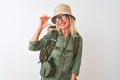 Middle age hiker woman wearing backpack hat canteen glasses over isolated white background smiling and confident gesturing with Royalty Free Stock Photo