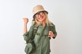 Middle age hiker woman wearing backpack hat canteen glasses over isolated white background smiling with happy face looking and Royalty Free Stock Photo