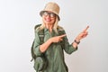 Middle age hiker woman wearing backpack hat canteen glasses over isolated white background smiling and looking at the camera Royalty Free Stock Photo