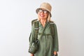 Middle age hiker woman wearing backpack hat canteen glasses over isolated white background smiling looking to the side and staring Royalty Free Stock Photo