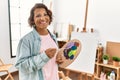 Middle age hispanic artist woman smiling happy drawing at art studio Royalty Free Stock Photo