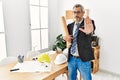 Middle age hispanic business man holding paper blueprints doing stop sing with palm of the hand Royalty Free Stock Photo