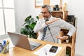 Middle age hispanic business man working at the office wearing operator headset gesturing with hands showing big and large size Royalty Free Stock Photo