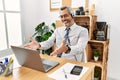 Middle age hispanic business man working at the office wearing operator headset looking at the camera smiling with open arms for Royalty Free Stock Photo