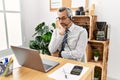 Middle age hispanic business man working at the office wearing operator headset thinking looking tired and bored with depression Royalty Free Stock Photo