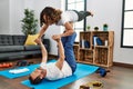 Middle age hispanic couple smiling happy doing acro sport at home Royalty Free Stock Photo