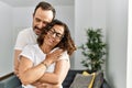 Middle age hispanic couple smiling happy and hugging on marriage proposal