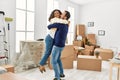 Middle age hispanic couple smiling happy and hugging at new home Royalty Free Stock Photo