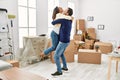 Middle age hispanic couple smiling happy and hugging at new home Royalty Free Stock Photo