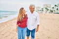 Middle age hispanic couple smiling happy walking at the beach Royalty Free Stock Photo