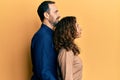 Middle age hispanic couple wearing casual clothes looking to side, relax profile pose with natural face and confident smile Royalty Free Stock Photo