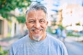 Middle age hispanic grey-haired man smiling happy standing at the city Royalty Free Stock Photo