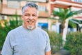 Middle age hispanic grey-haired man smiling happy standing at the park Royalty Free Stock Photo