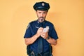 Middle age hispanic man wearing police uniform writing traffic fine skeptic and nervous, frowning upset because of problem