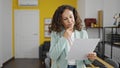 Middle age hispanic woman business worker reading document with doubt expression at office Royalty Free Stock Photo