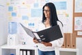 Middle age hispanic woman business worker reading document at office Royalty Free Stock Photo