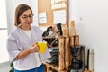 Middle age hispanic woman businesswoman drinking cup of coffee at business office Royalty Free Stock Photo