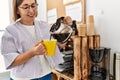 Middle age hispanic woman businesswoman drinking cup of coffee at business office Royalty Free Stock Photo