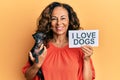 Middle age hispanic woman holding chihuahua dog and paper with i love dogs phrase smiling with a happy and cool smile on face Royalty Free Stock Photo