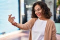 Middle age hispanic woman moving hand asking to come nearer outdoors Royalty Free Stock Photo