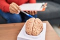 Middle age hispanic woman psychologist pointing to brain at psychology center Royalty Free Stock Photo