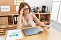 Middle age hispanic woman reading paperwork working at office Royalty Free Stock Photo