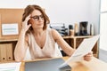 Middle age hispanic woman reading paperwork working at office Royalty Free Stock Photo