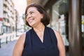 Middle age hispanic woman smiling happy and confident outdoors on a sunny day Royalty Free Stock Photo