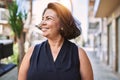 Middle age hispanic woman smiling happy and confident outdoors on a sunny day Royalty Free Stock Photo