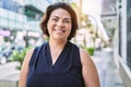 Middle age hispanic woman smiling happy and confident outdoors on a sunny day Royalty Free Stock Photo