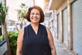 Middle age hispanic woman smiling happy and confident outdoors on a sunny day Royalty Free Stock Photo