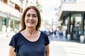 Middle age hispanic woman smiling happy outdoors on a sunny day Royalty Free Stock Photo