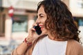 Middle age hispanic woman speaking on the phone outdoors Royalty Free Stock Photo