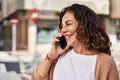 Middle age hispanic woman speaking on the phone outdoors Royalty Free Stock Photo